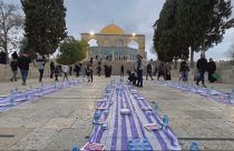 Still of worshippers arranging fast-breaking iftar meals at the Al-Aqsa mosque compound