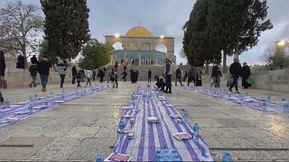 Still of worshippers arranging fast-breaking iftar meals at the Al-Aqsa mosque compound