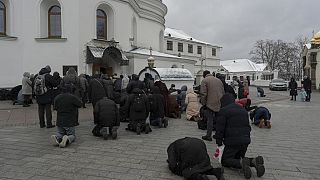People pray in the Kyiv Pechersk Lavra monastery complex in Kyiv, Ukraine, Wednesday, March 29, 2023.