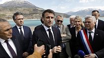 French President Emmanuel Macron, center, speaks to journalists upon his arrival in Sainte-Savine-Le-Lac, southeastern France, Thursday, March 30, 2023