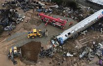 The wreckage of the trains lie next to the rail lines, after Tuesday's rail crash, the country's deadliest on record.
