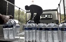 Municipal employees load packages of drinking water to be delivered to the residents of Corbere-les-Cabanes, southwestern France.