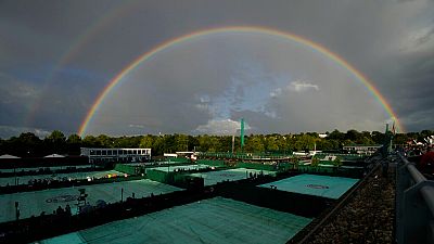 A rainbow arches in the sky as seen from the courts on day four of the Wimbledon tennis championships in London, Thursday, June 30, 2022.