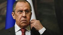 Russian Foreign Minister Sergey Lavrov inserts an earphone during a news conference with his Iranian counterpart Hossein Amirabollahian following talks in Moscow, March 29.