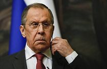 Russian Foreign Minister Sergey Lavrov inserts an earphone during a news conference with his Iranian counterpart Hossein Amirabollahian following talks in Moscow, March 29.