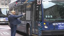 Man in Trump mask directs traffic in New York.