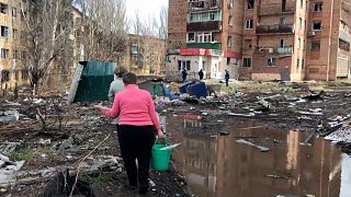 Locals inspect the site of the Russian deadly missile attack in Kostiantynivka, Donetsk region, Ukraine, Sunday, April 2, 2023.