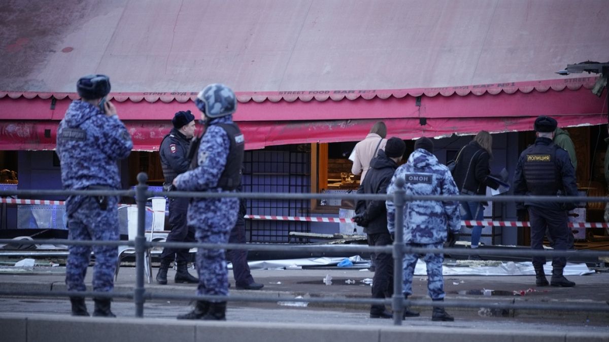 Russian police officers stand at the side of an explosion at a cafe in St. Petersburg, Russia, April 2, 2023.