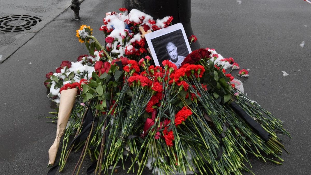 A portrait of Russian military blogger Vladlen Tatarsky is seen among flowers at a makeshift memorial by the explosion site in Saint Petersburg on April 3, 2023.