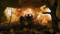 Ukrainian soldiers fire artillery at Russian positions near Bakhmut. 