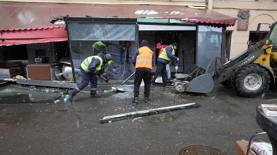 Trabalhadores municipais limpam o local da explosão.