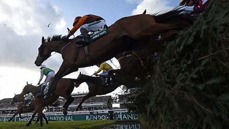 Riders on the final day of the Grand National Festival horse race meeting at Aintree Racecourse in Liverpool in 2022.