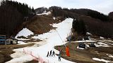 Skiers stand on an artificial snow slope as end of the ski season nears in Monte Cimone, Italy, 31 March 2023.