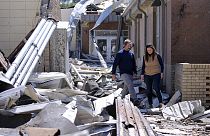 Wynne School Superintendent Kenneth Moore, left, leads Gov. Sarah Huckabee Sanders through the Wynne High School that was hit by Friday's tornado