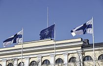 La bandera de la OTAN, en el centro, y las banderas de Finlandia ondean sobre el edificio del Ministerio de Asuntos Exteriores en Helsinki
