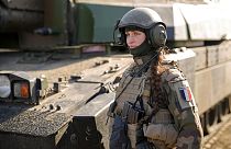 A French servicewoman, member of a Leclerc main battle tank crew.