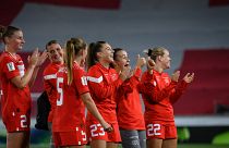 Switzerland players applaud next to a giant Swiss flag at the end of the FIFA Women's World Cup 2023 between Switzerland and Moldova on September 6, 2022.