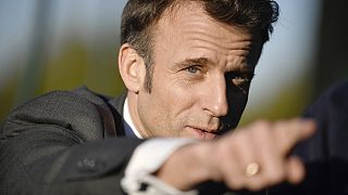 French President Emmanuel Macron gestures as he attends a soccer training session for neurodivergent children outside Paris, Tuesday April 4, 2023.