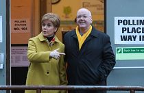 FILE: Former Scottish First Minister Nicola Sturgeon poses for the media with husband Peter Murrell, outside polling station in Glasgow, Scotland, December 2019