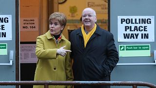 FILE: Former Scottish First Minister Nicola Sturgeon poses for the media with husband Peter Murrell, outside polling station in Glasgow, Scotland, December 2019
