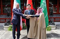 Iran's Foreign Minister Hossein Amir-Abdollahian (L) shakes hands with his counterparts; Saudi Arabia's Prince Faisal bin Farhan and China's Qin Gang at a meeting in Beijing