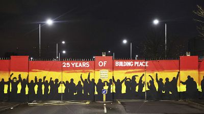 A mural on the peace gates at Lanark Way In Belfast celebrates 25 years since the Good Friday Agreement