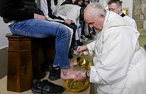 Pope Francis washing the feet of an inmate