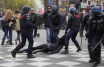 Riot police officers detain a youth during a demonstration Thursday, April 6, 2023 in Paris