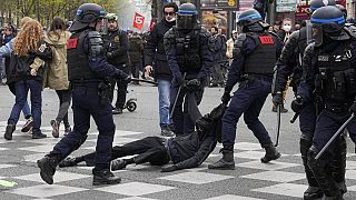 Riot police officers detain a youth during a demonstration Thursday, April 6, 2023 in Paris