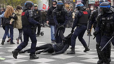 Riot police officers detain a youth during a demonstration Thursday, April 6, 2023 in Paris