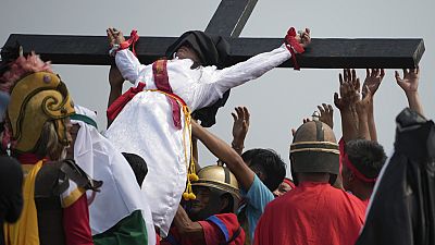 Village actors dressed as Roman centurions hammer nails through the devotees' palms and feet,