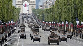 Armored vehicles drive down on the Champs-Elysees avenue during the annual Bastille Day military parade in Paris on July 14, 2021.