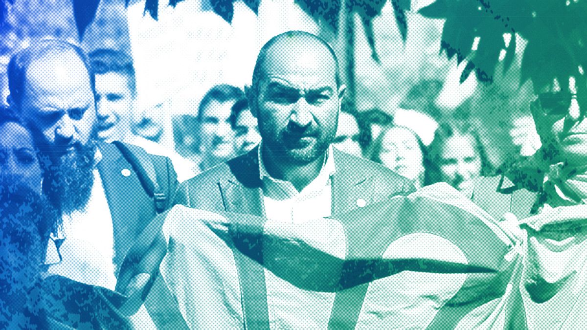 Željko Jovanović holds the Roma flag during an anti-racism march celebrating the Romani Resistance Day in Bucharest, 18 May 2019