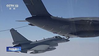 In this image taken from video footage run Saturday, April 8, 2023 by China's CCTV, a Chinese fighter jet performs an mid-air refueling maneuver at an unspecified location.
