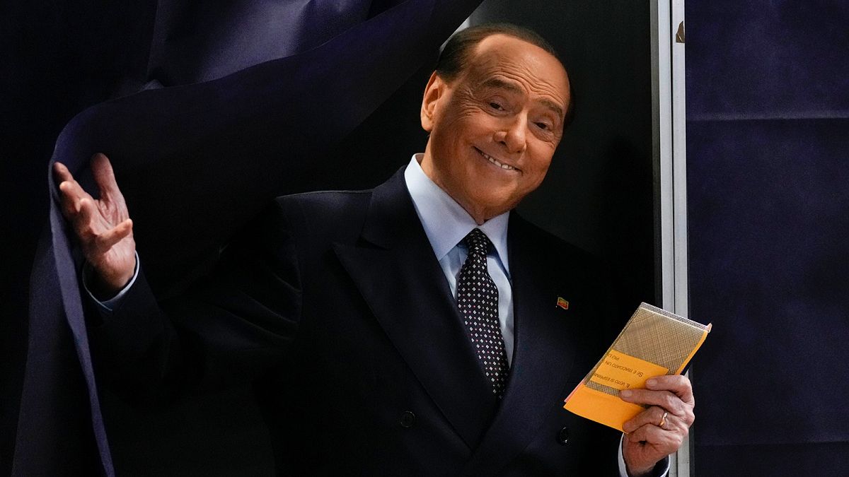 Silvio Berlusconi comes out of a voting booth before casting his ballot at a polling station in Milan, 25 September 2022