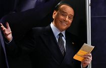 Silvio Berlusconi comes out of a voting booth before casting his ballot at a polling station in Milan, 25 September 2022