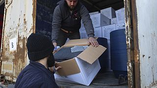 Border customs officials inspect a truck loaded with United Nations humanitarian aid for Syria following a devastating quake at the Bab al-Hawa border crossing with Turkey.