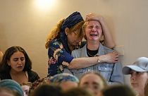 Mourners attend the funeral of two British-Israeli sisters, Maia and Rina Dee, at a cemetery in the Jewish settlement of Kfar Etzion in the occupied West Bank, Sunday, April 9