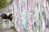 Tourists sign the “peace walls” that still separate some nationalist and unionist neighborhoods in west Belfast, Northern Ireland, Wednesday, April 5, 2023.