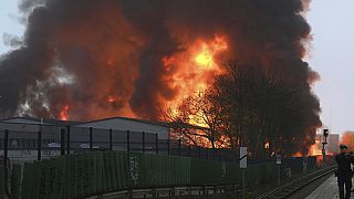 Huge flames rise from a fire in Hamburg, Germany, Sunday April 9, 2023.