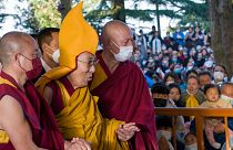 Tibetan spiritual leader the Dalai Lama in a ceremonial yellow hat arrives at the Tsuglakhang temple to give a sermon in Dharamshala, India.