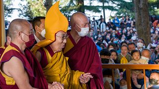 Tibetan spiritual leader the Dalai Lama in a ceremonial yellow hat arrives at the Tsuglakhang temple to give a sermon in Dharamshala, India.