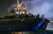 A fishing boat with some 500 migrants enters the southern Italian port of Crotone, early Saturday, March 11, 2023. 