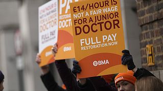 FILE - Junior doctors hold placards on a picket line outside St Mary's Hospital in London, Tuesday, March 14, 2023.