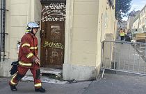 A firefighter walks near the scene where a building collapsed, in Marseille, southern France, April 10, 2023. 