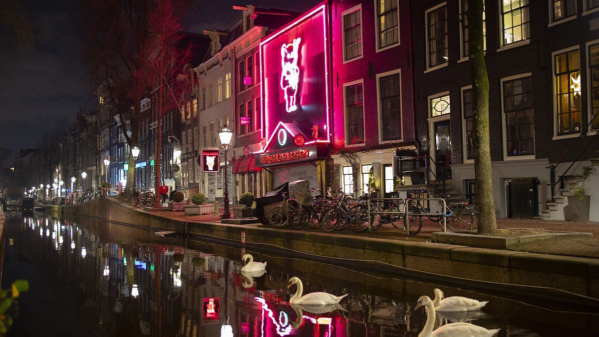 Apart from a few swans Amsterdam Red Light District, with the Casa Rosso erotic theatre is deserted in Amsterdam, Netherlands.