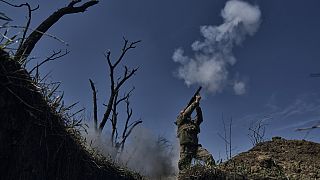 A Ukrainian soldier fires a grenade launcher on the frontline in Bakhmut, Donetsk region, Ukraine, Monday, April 10, 2023.