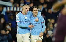 Man City's Erling Haaland, left, celebrates with his teammate Jack Grealish at the end of their Champions League quarterfinal, first leg game