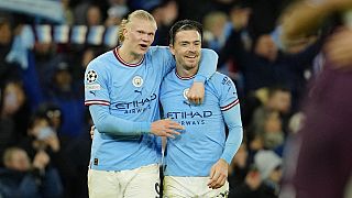 Man City's Erling Haaland, left, celebrates with his teammate Jack Grealish at the end of their Champions League quarterfinal, first leg game