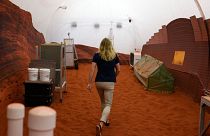 Dr. Suzanne Bell, Lead for NASA’s Behavioral Health and Performance Laboratory, walks through a simulated Mars exterior portion of the CHAPEA’s Mars Dune Alpha.